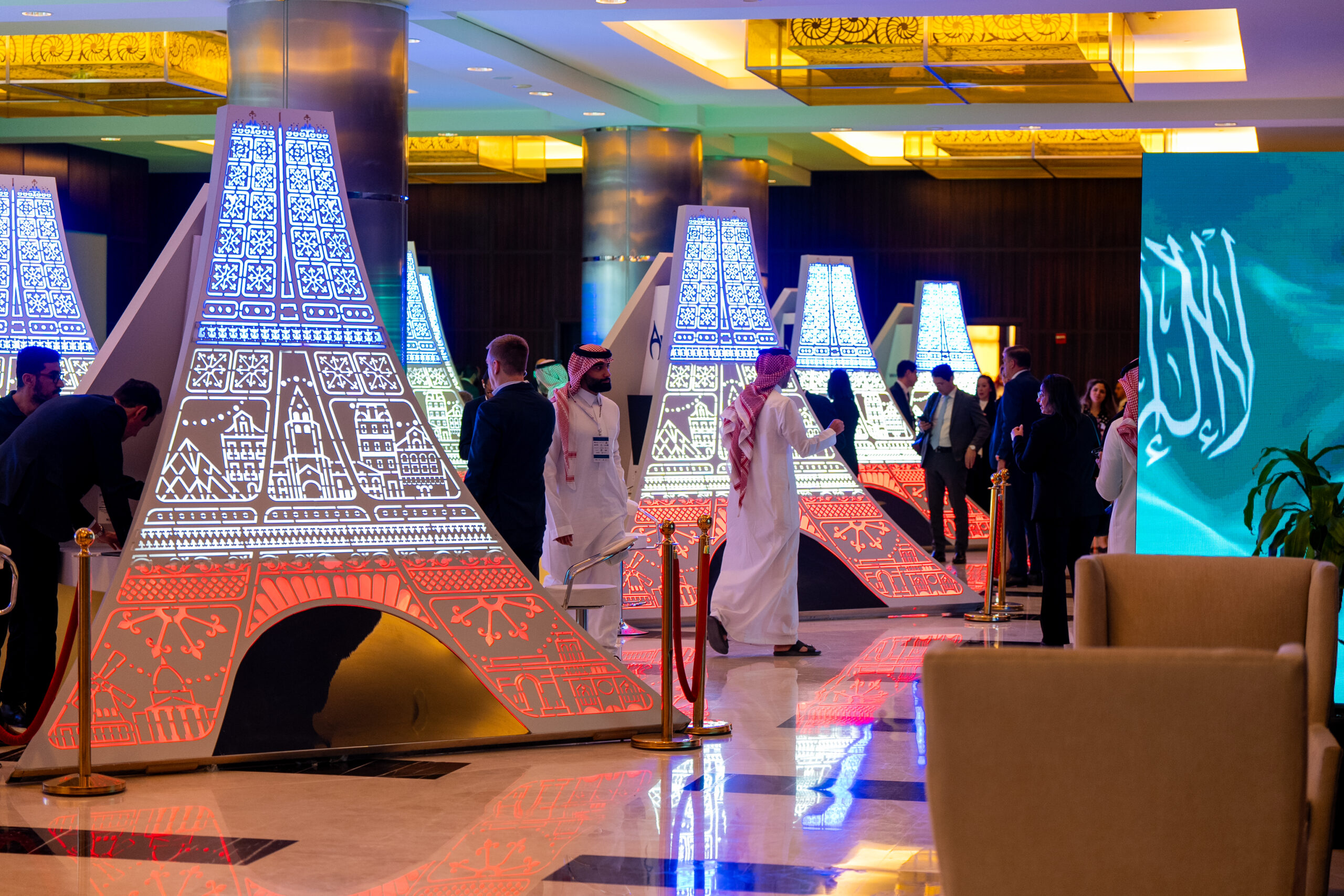 The towers glowing tricolor with guests passing