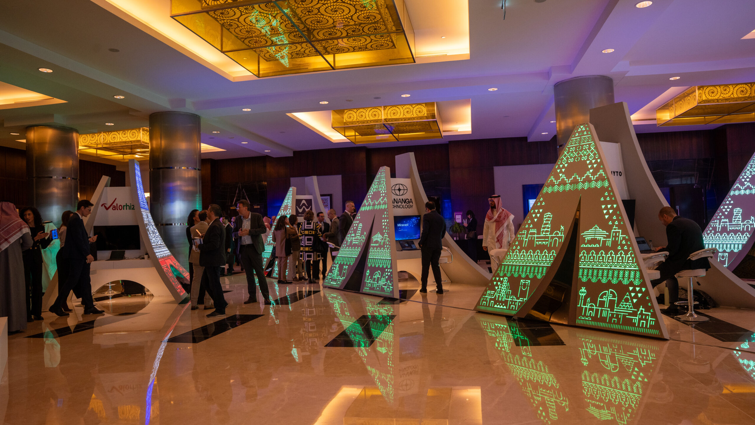 The green Saudi face of the towers reflected on the foyer floor